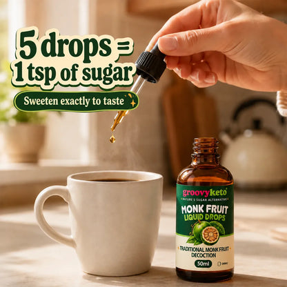 A hand holds a glass dropper above a white mug, with a bottle of Groovy Keto Monk Fruit Liquid Drops beside it on a kitchen counter. Large text reads '5 drops = 1 tsp of sugar' and 'Sweeten exactly to taste'.