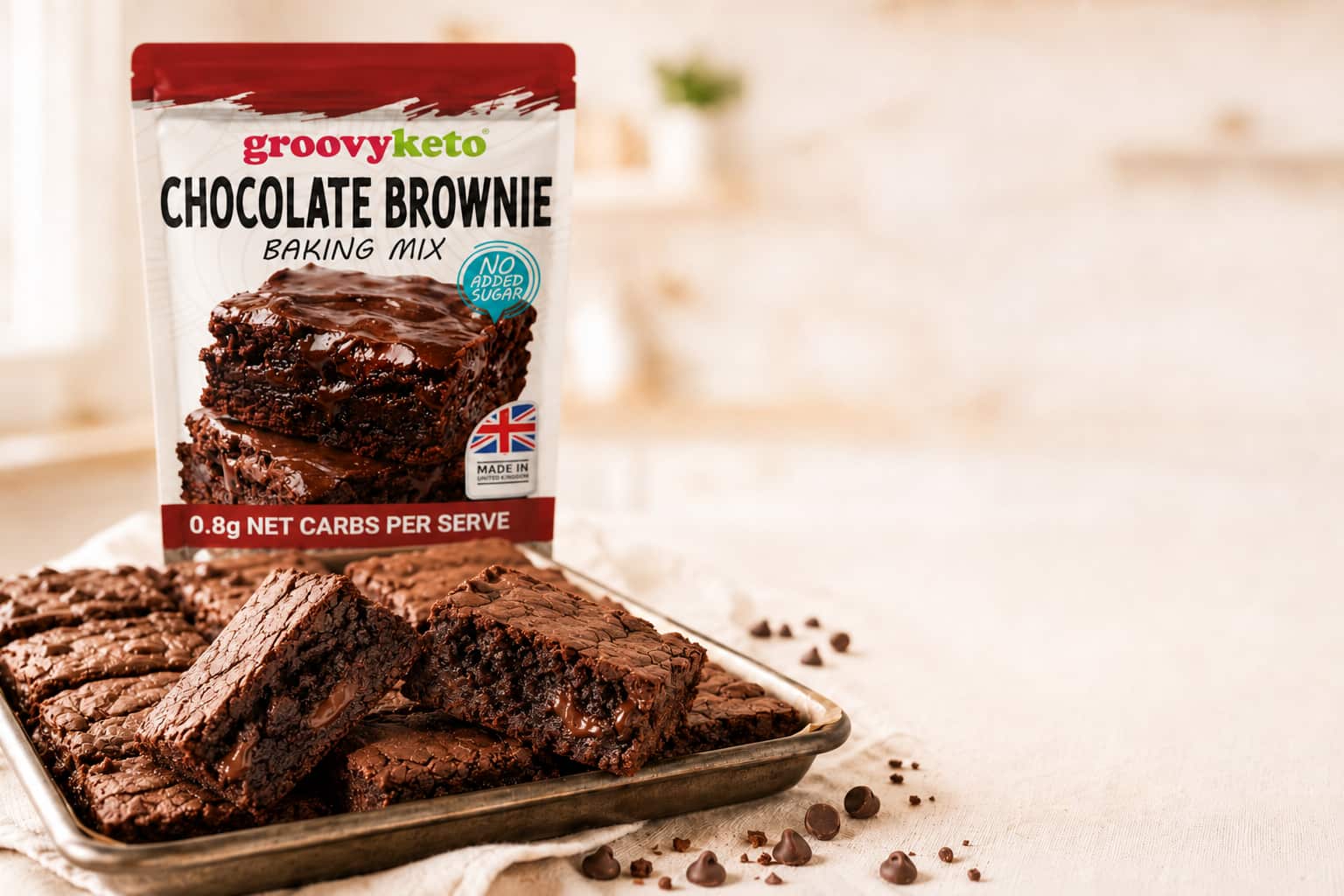 Groovy Keto Chocolate Brownie Baking Mix pouch beside a tray of freshly baked keto brownies showing fudgy texture