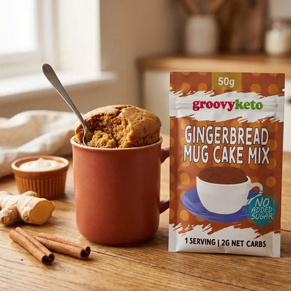 Groovy Keto gingerbread mug cake mix sachet next to a freshly made gingerbread mug cake in a mug